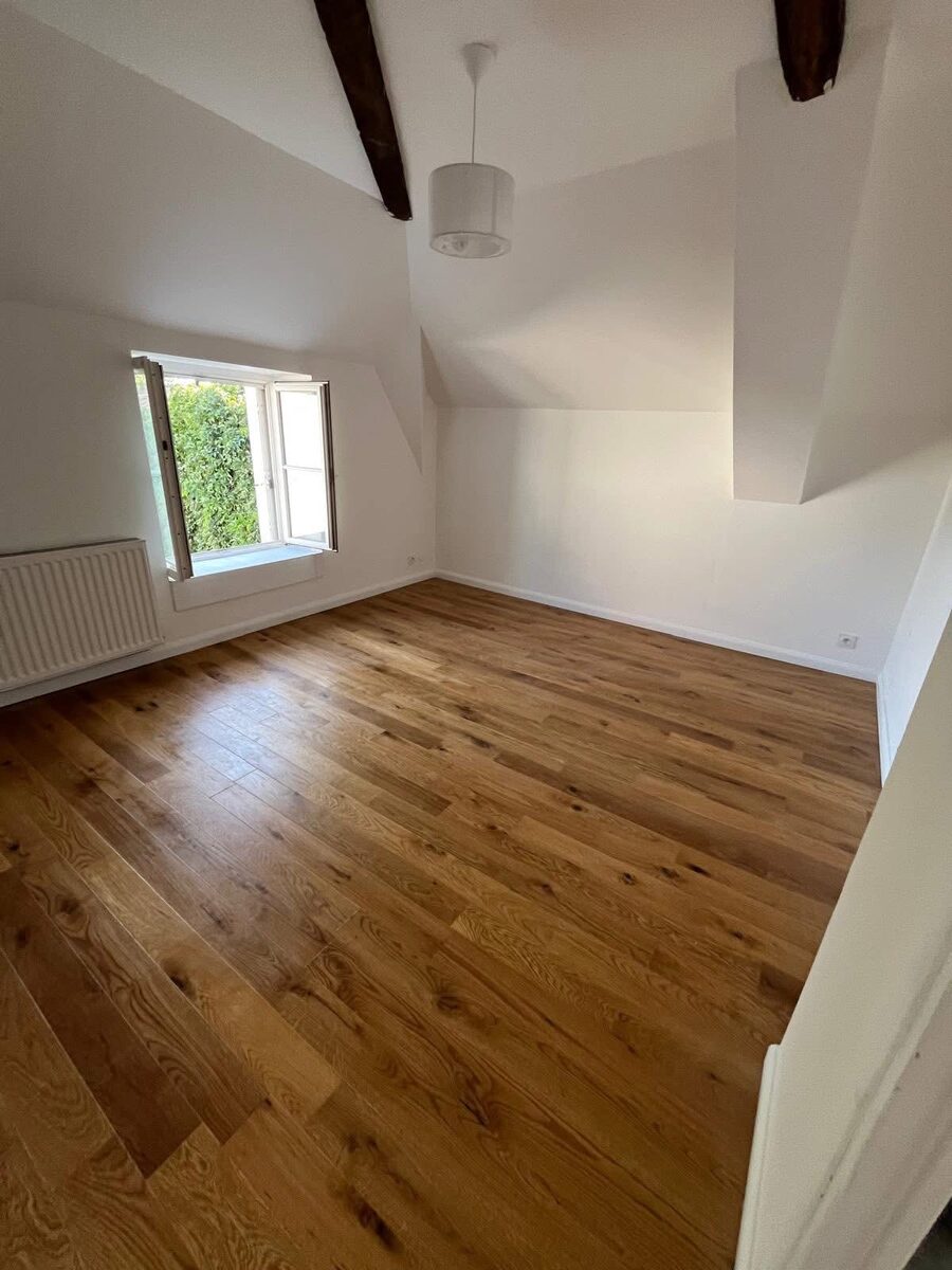 Completed oak hardwood floor in a Hove bedroom with casement window