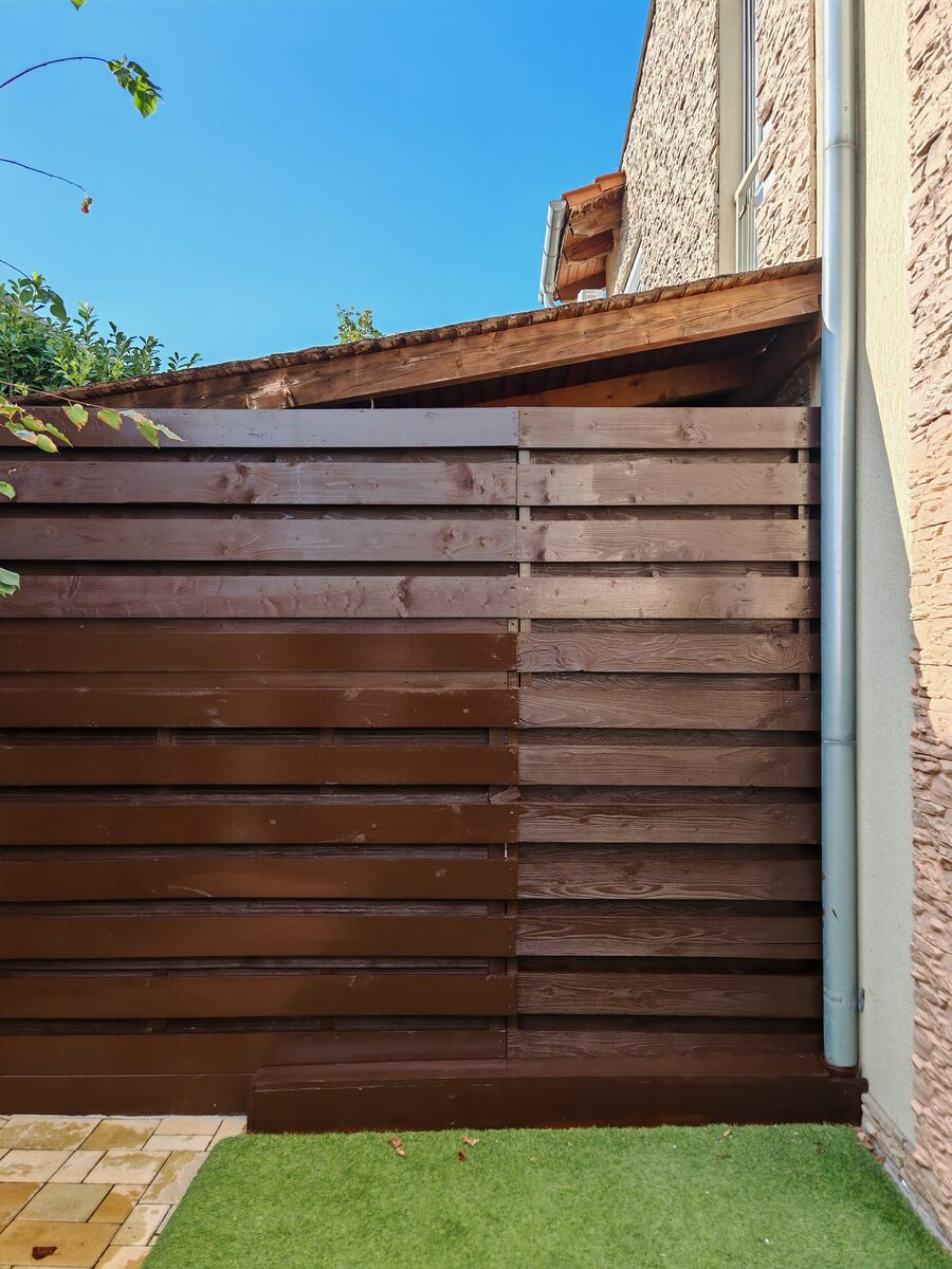 Real wood horizontal fence — dark brown stained, Brighton
