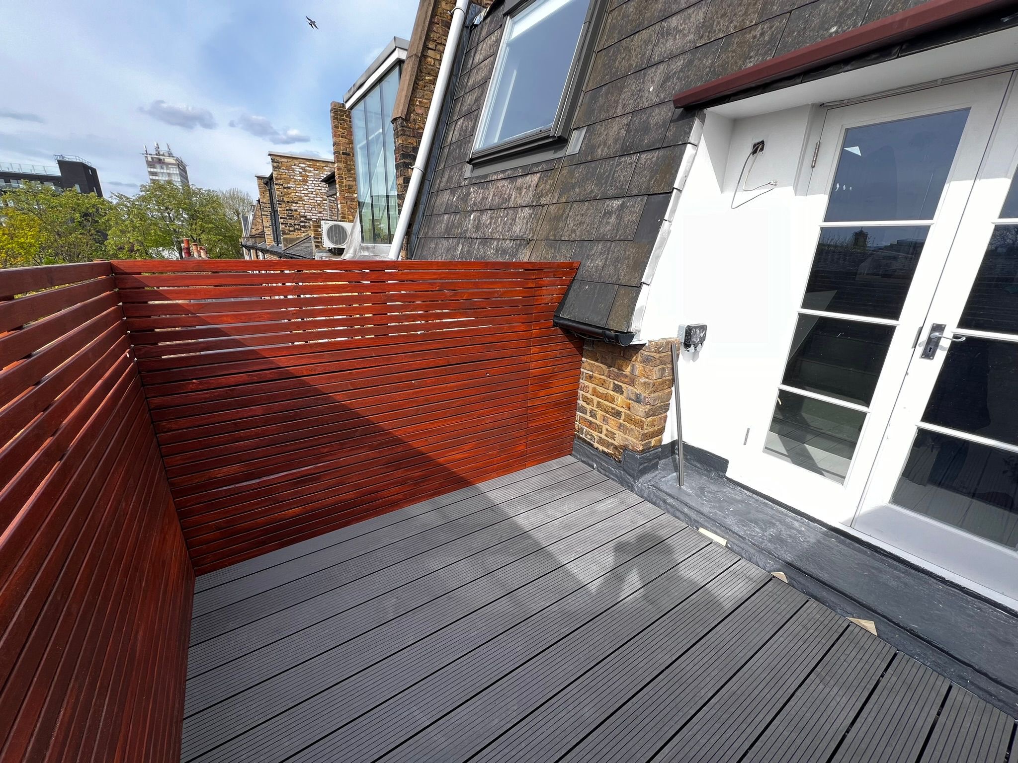 Rooftop terrace composite decking with French doors