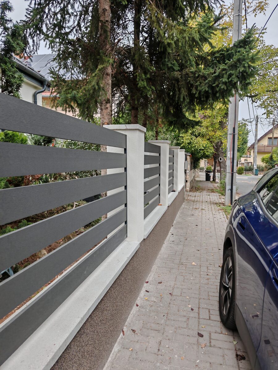 WPC composite grey slatted fence with rendered pillars